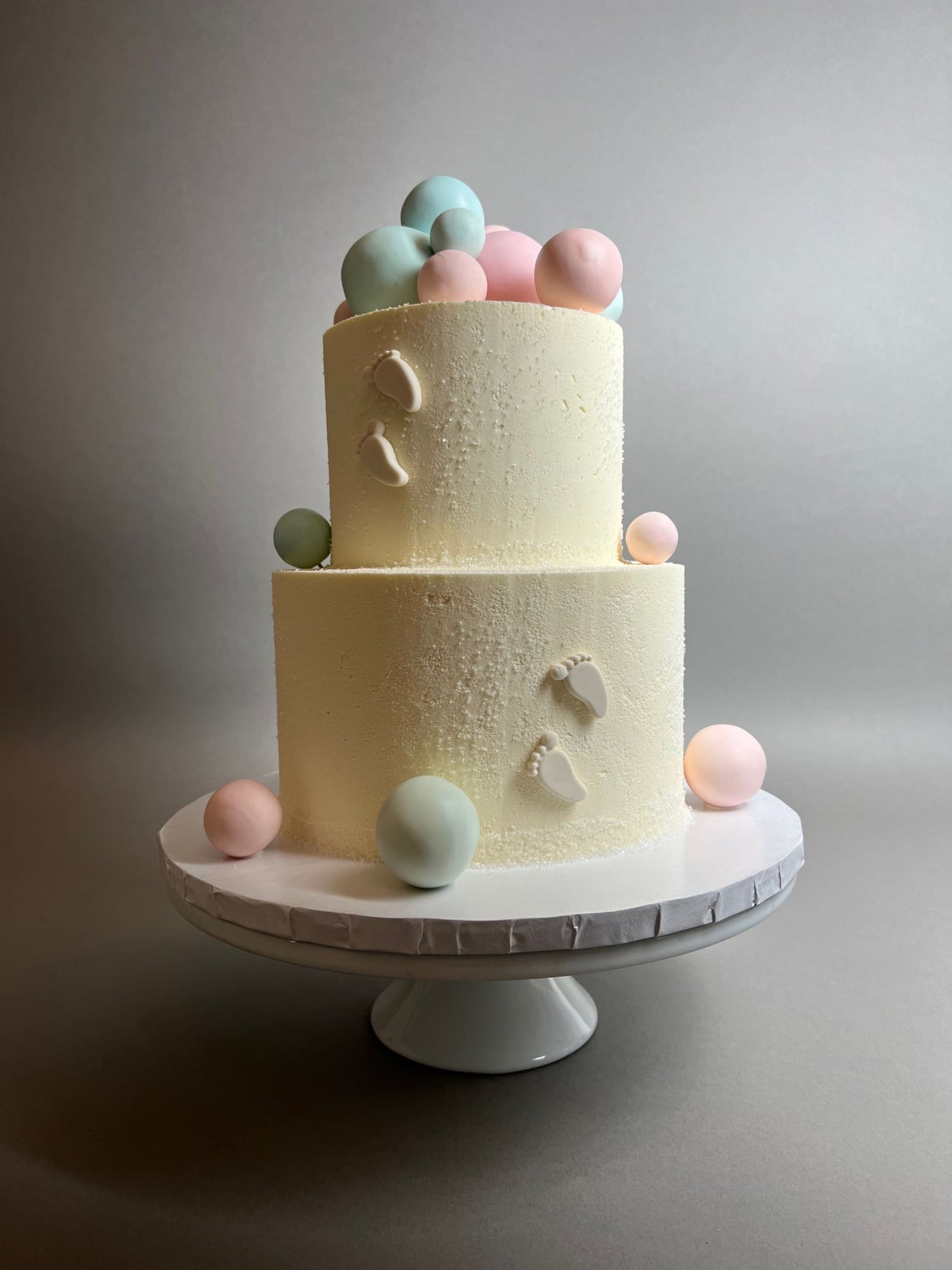 Spheres and footprints on buttercream - custom cake