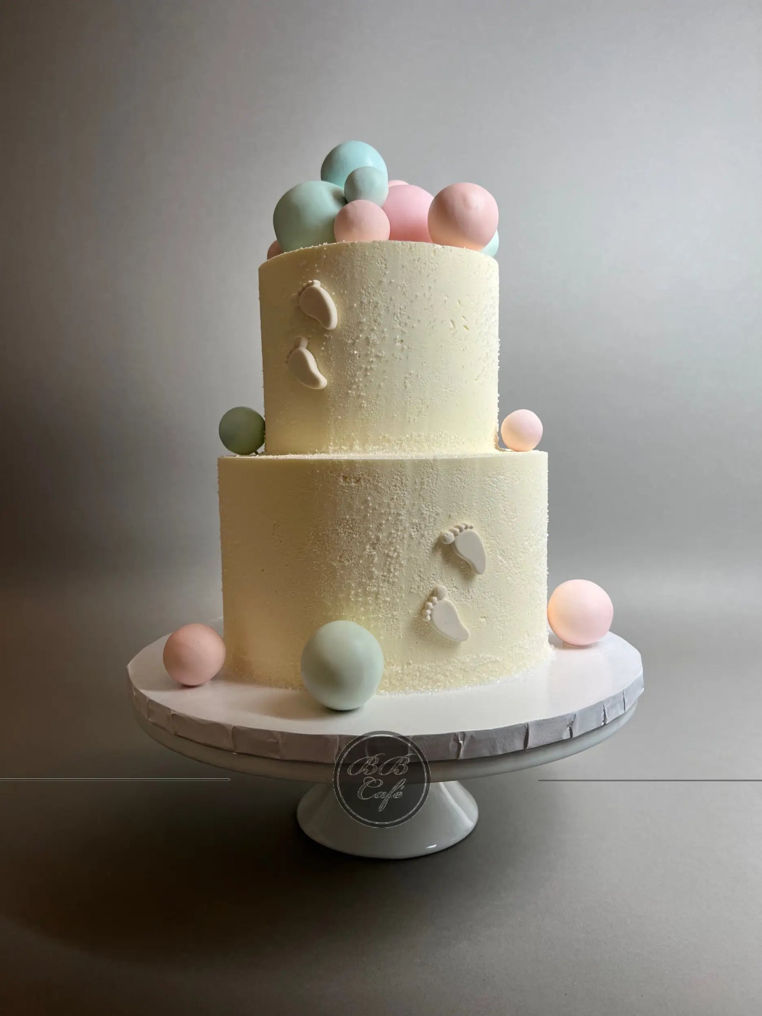 Spheres and footprints on buttercream - custom cake