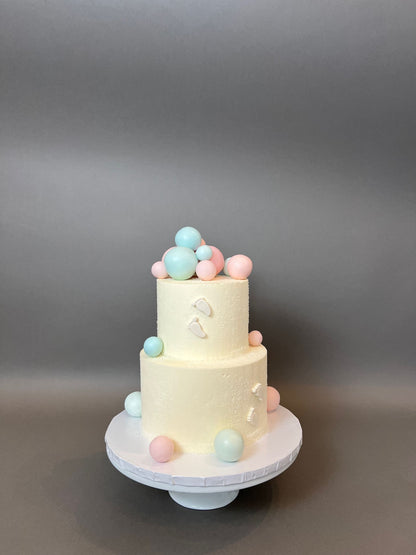 Spheres and footprints on buttercream - custom cake