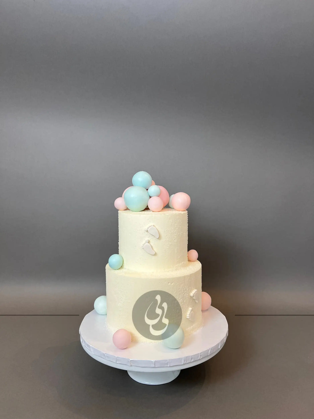 Spheres and footprints on buttercream - custom cake