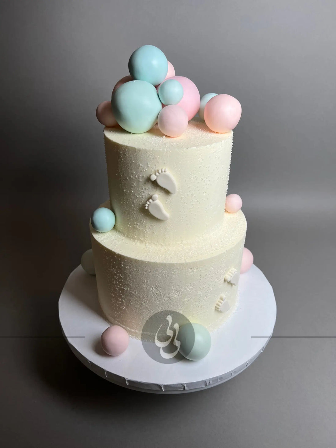 Spheres and footprints on buttercream - custom cake