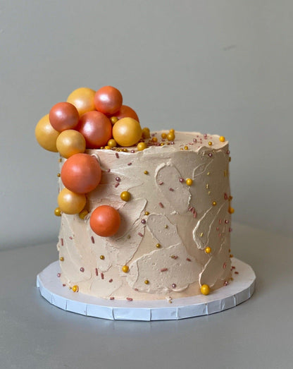 Splashed &amp; textured spheres on buttercream - custom cake