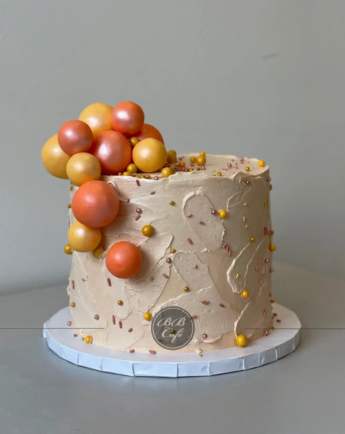 Splashed &amp; textured spheres on buttercream - custom cake