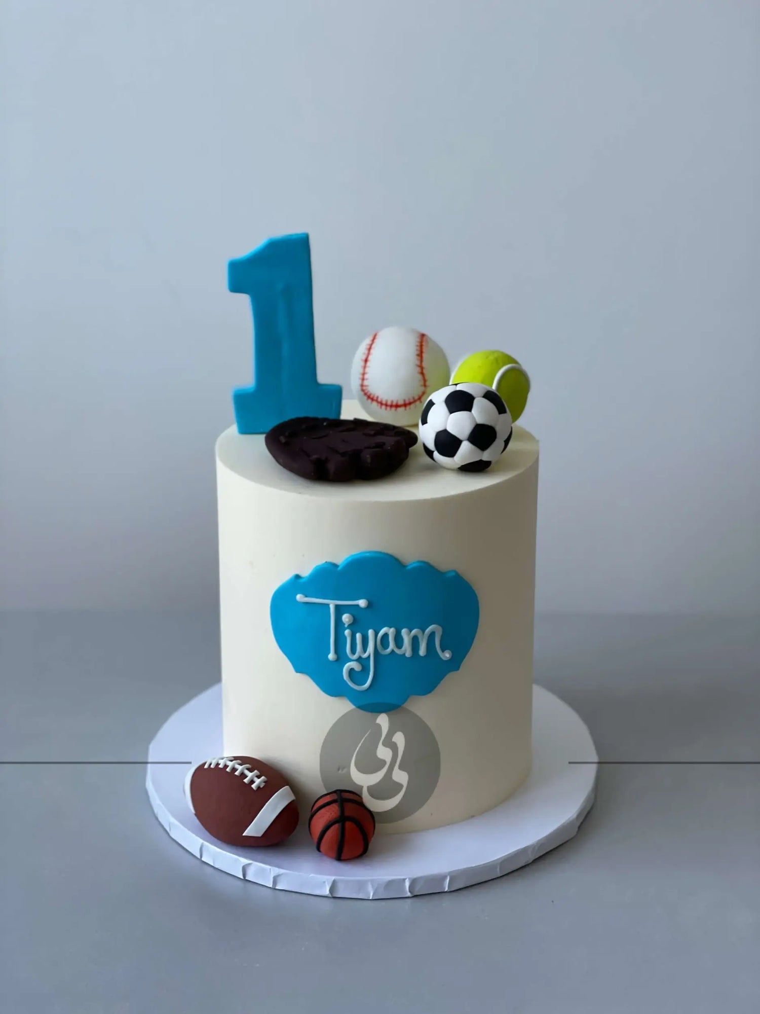 Sports balls on buttercream - custom cake