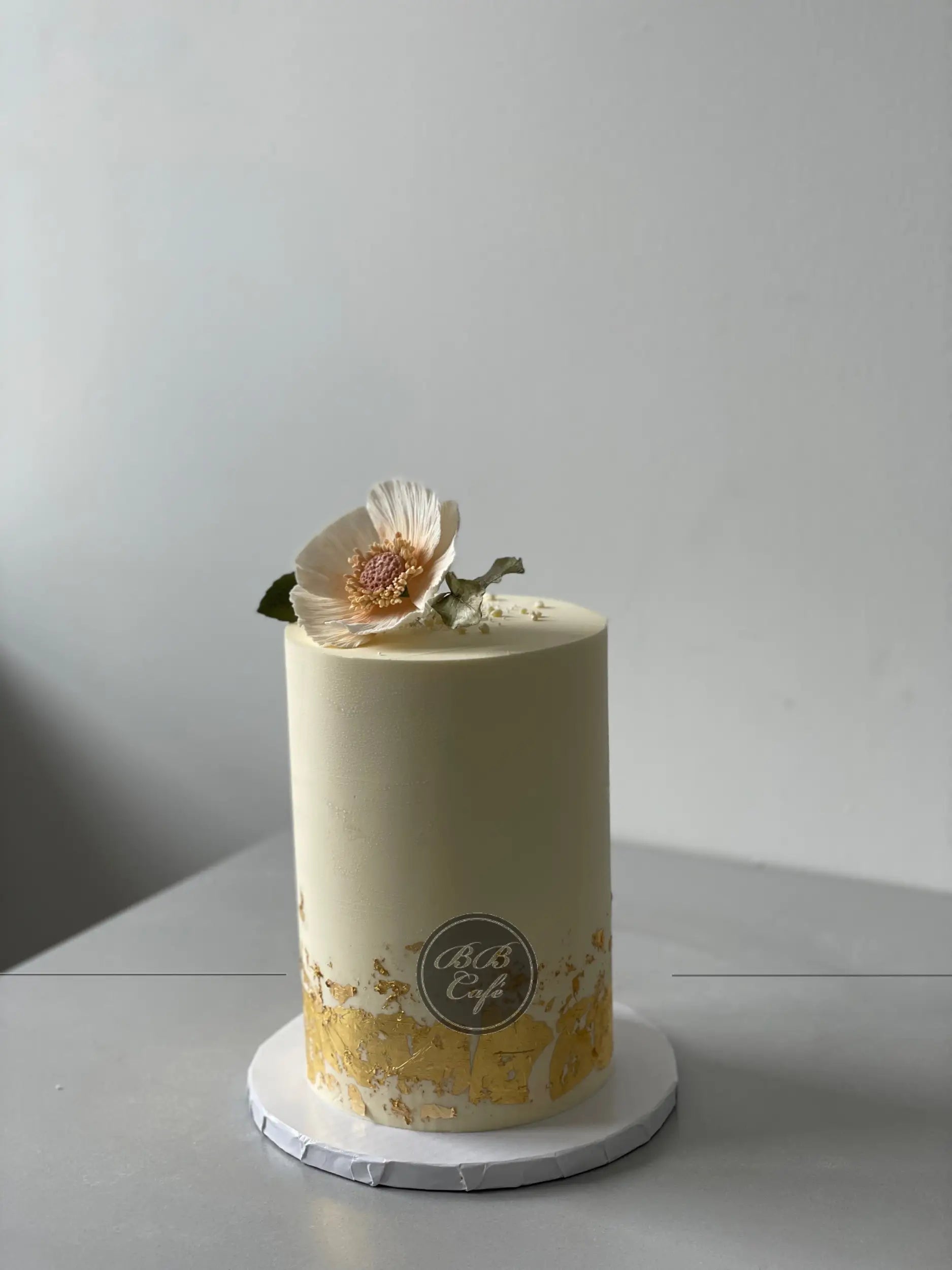 Sugar flower &amp; gold foil on buttercream - custom cake