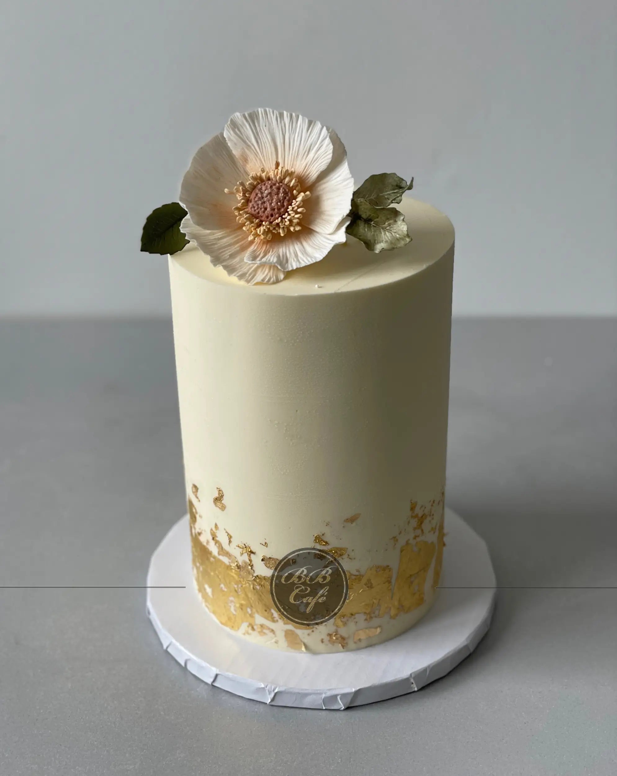 Sugar flower &amp; gold foil on buttercream - custom cake