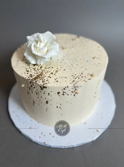 Sugar flowers &amp; gold splatter on buttercream - custom cake