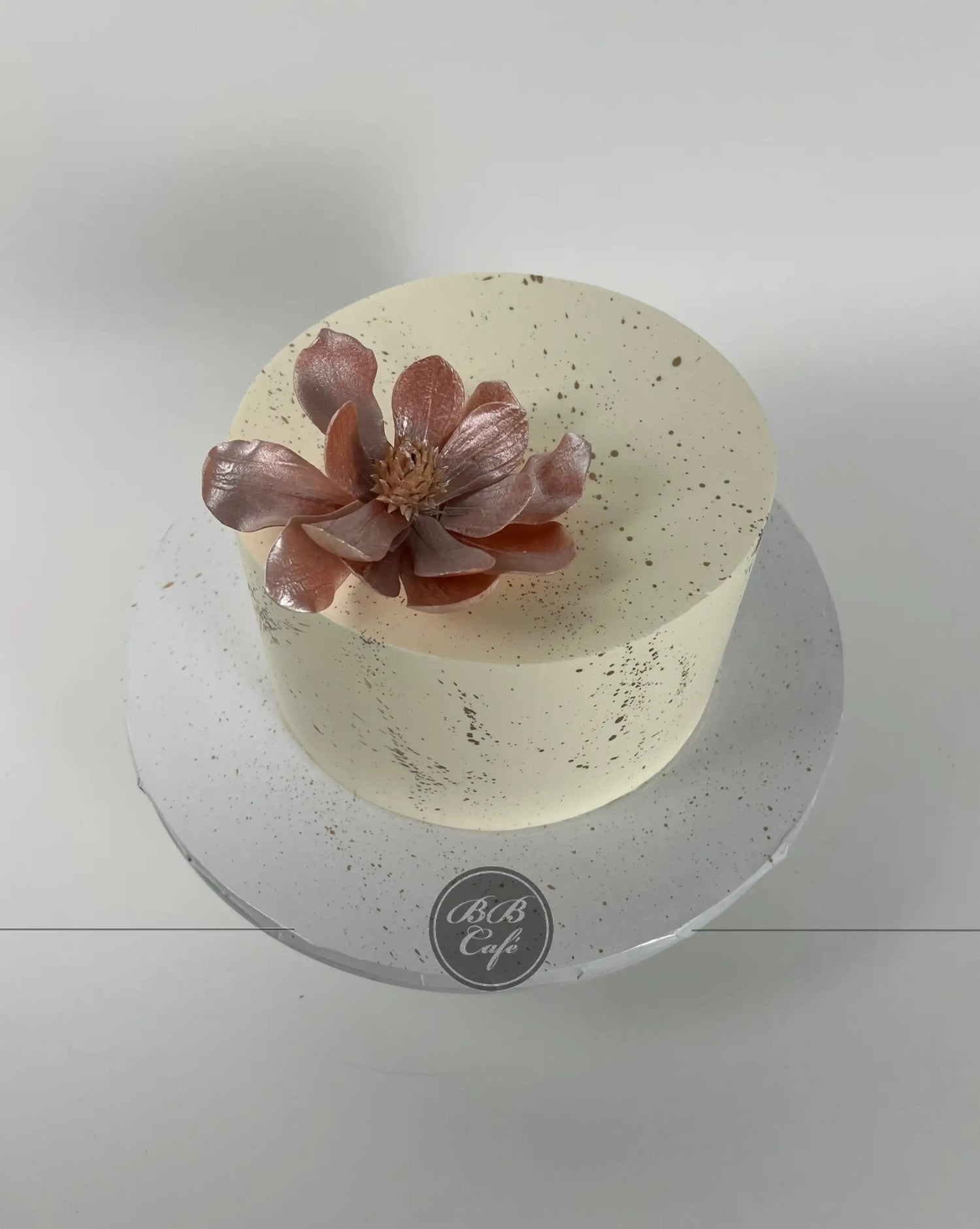 Sugar flowers &amp; gold splatter on buttercream - custom cake