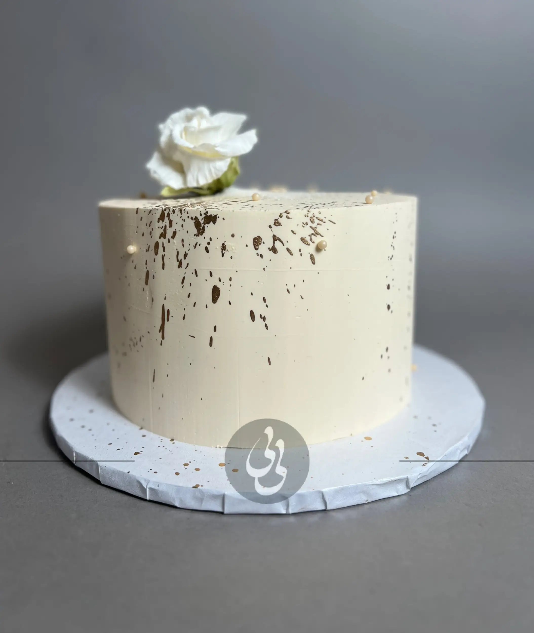 Sugar flowers &amp; gold splatter on buttercream - custom cake