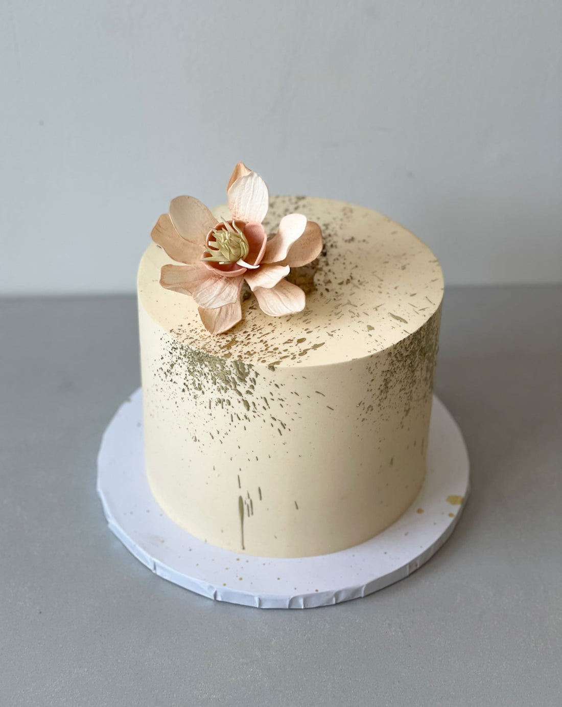 Sugar flowers &amp; gold splatter on buttercream - custom cake