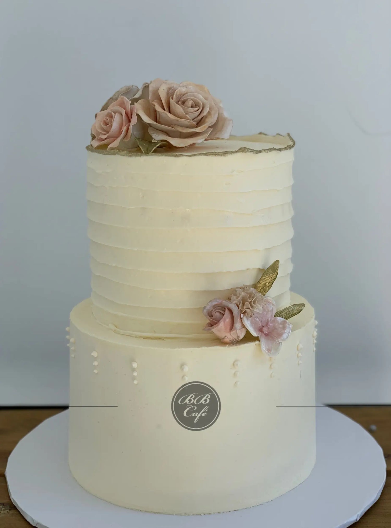 Sugar flowers on golden deckled edge buttercream - custom cake