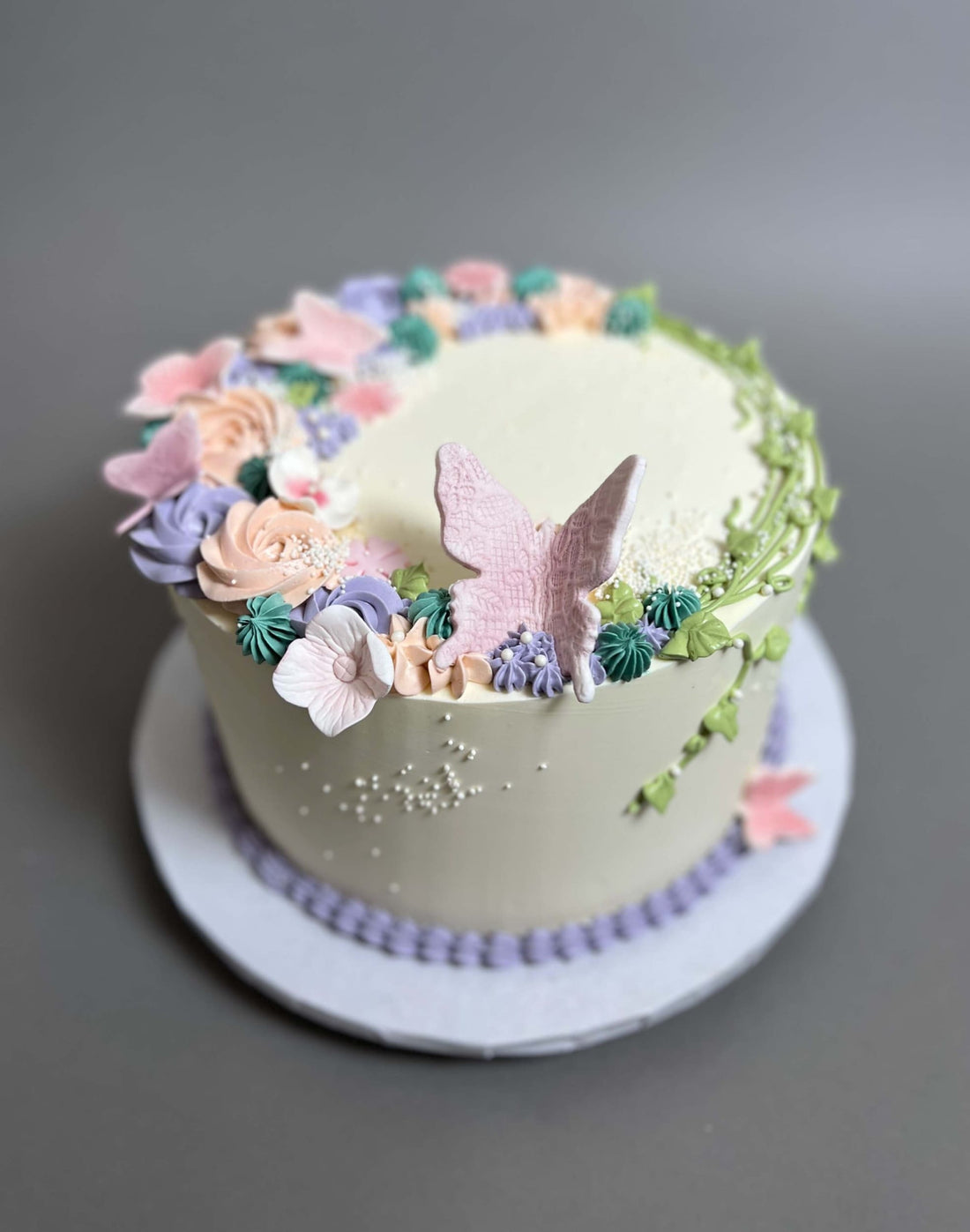 Vines and rosette butterfly on buttercream - custom cake