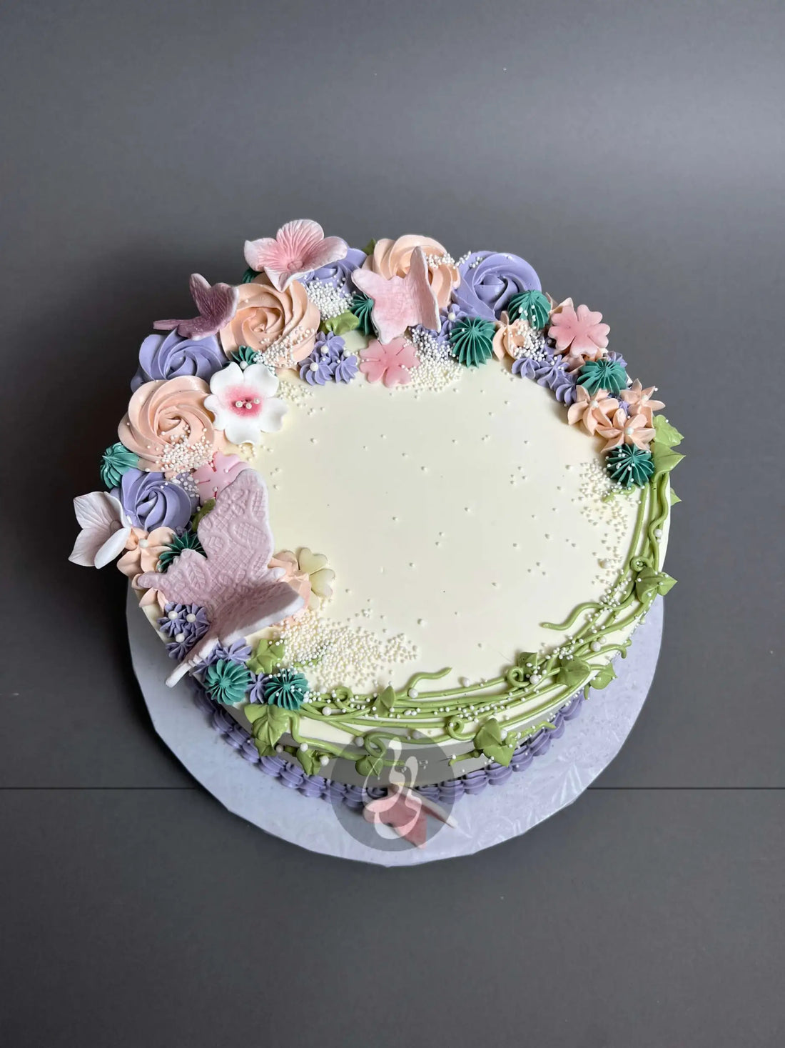 Vines and rosette butterfly on buttercream - custom cake