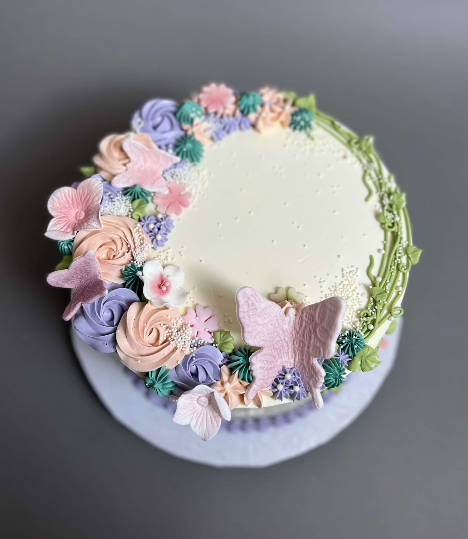Vines and rosette butterfly on buttercream - custom cake