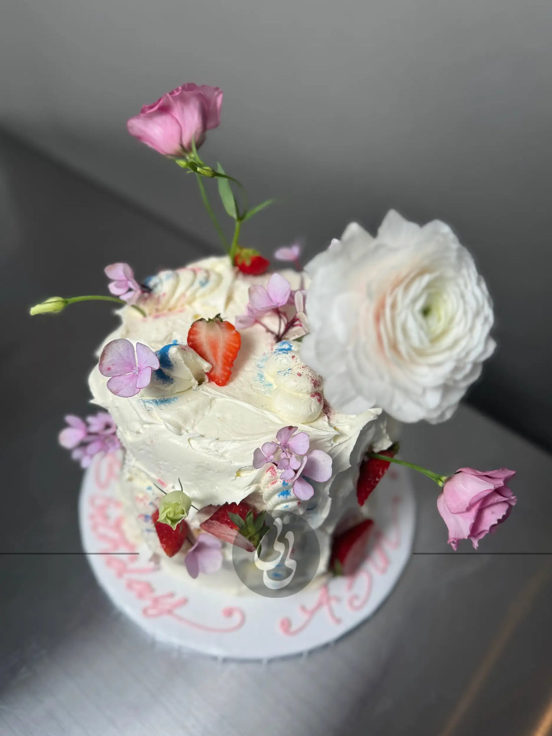 Wild fresh flowers &amp; strawberries on buttercream - custom cake