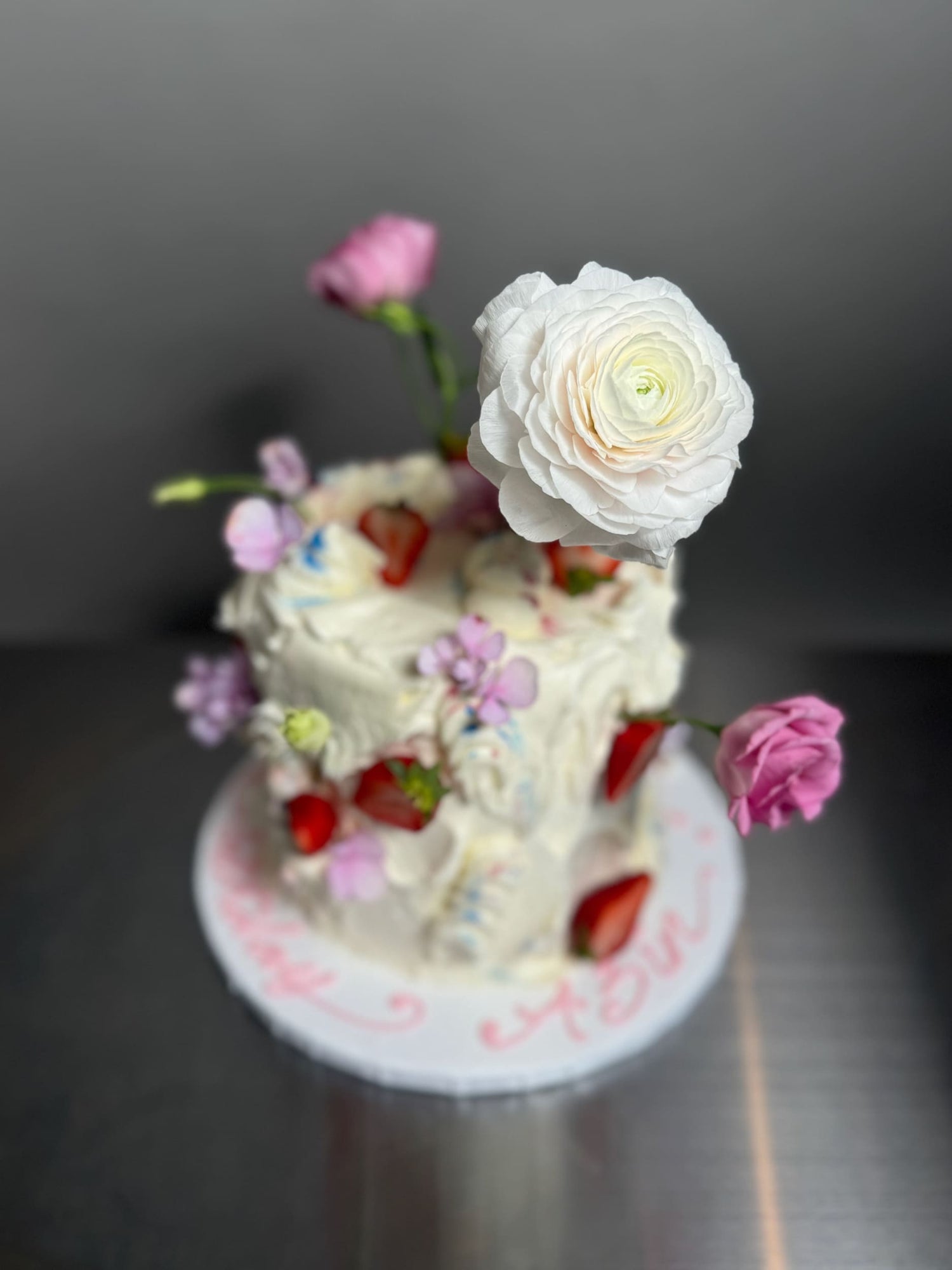 Wild fresh flowers &amp; strawberries on buttercream - custom cake