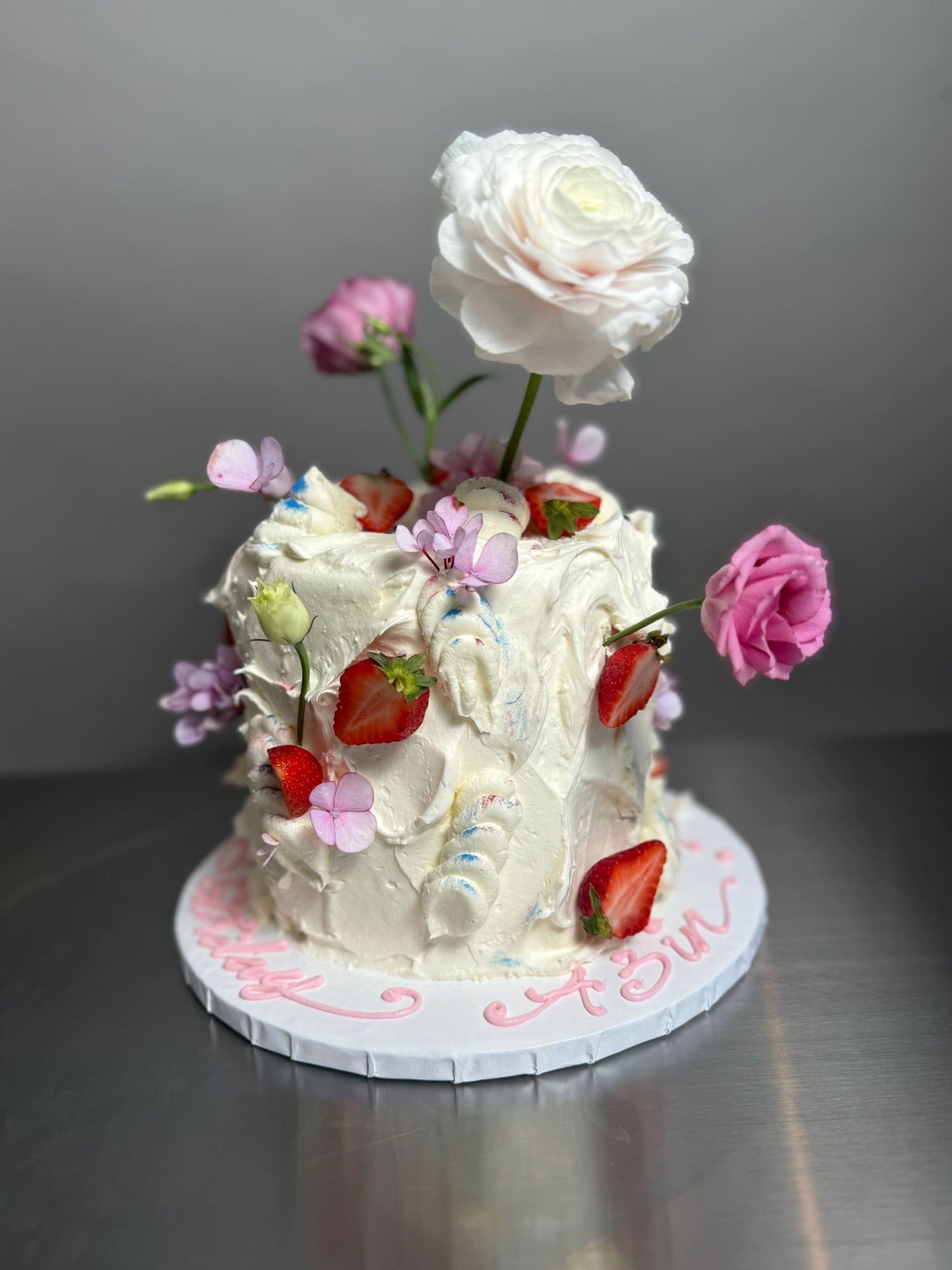 Wild fresh flowers &amp; strawberries on buttercream - custom cake